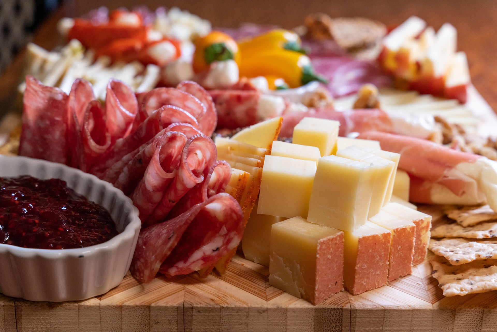 The well-stocked charcuterie board delights with a variety of cheeses, meats, and a heavenly baked brie, a true culinary treasure.