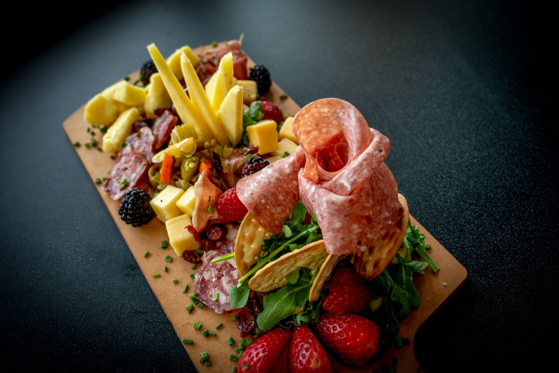A Charcutierie Platter Arranged With A Variety Of Meats, Cheeses And Fruit