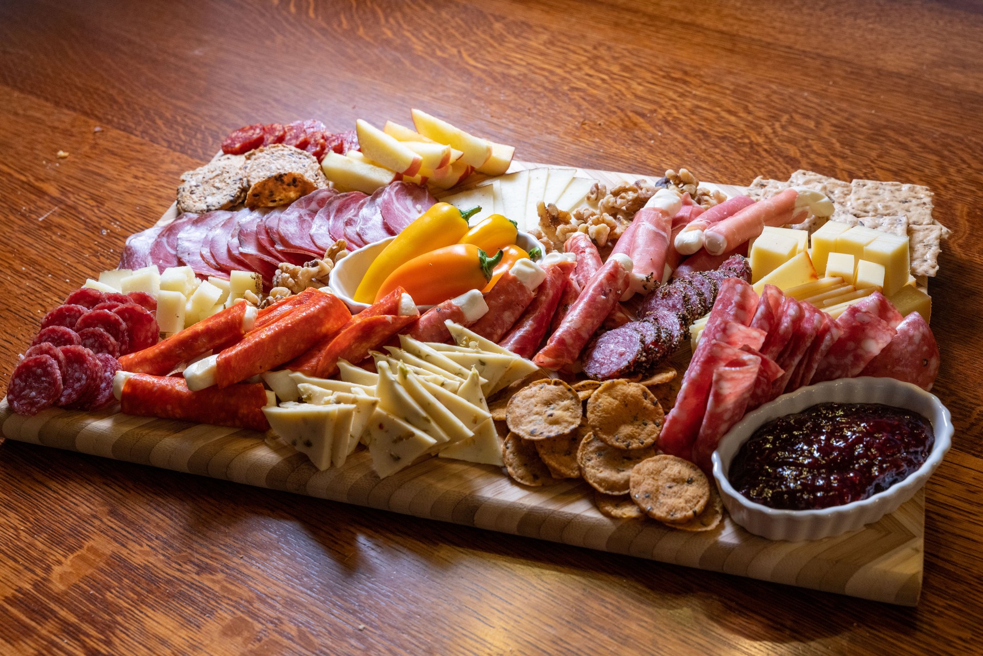 The charcuterie board overflows with an assortment of cheeses, meats, and a divine baked brie, an opulent delight for all.