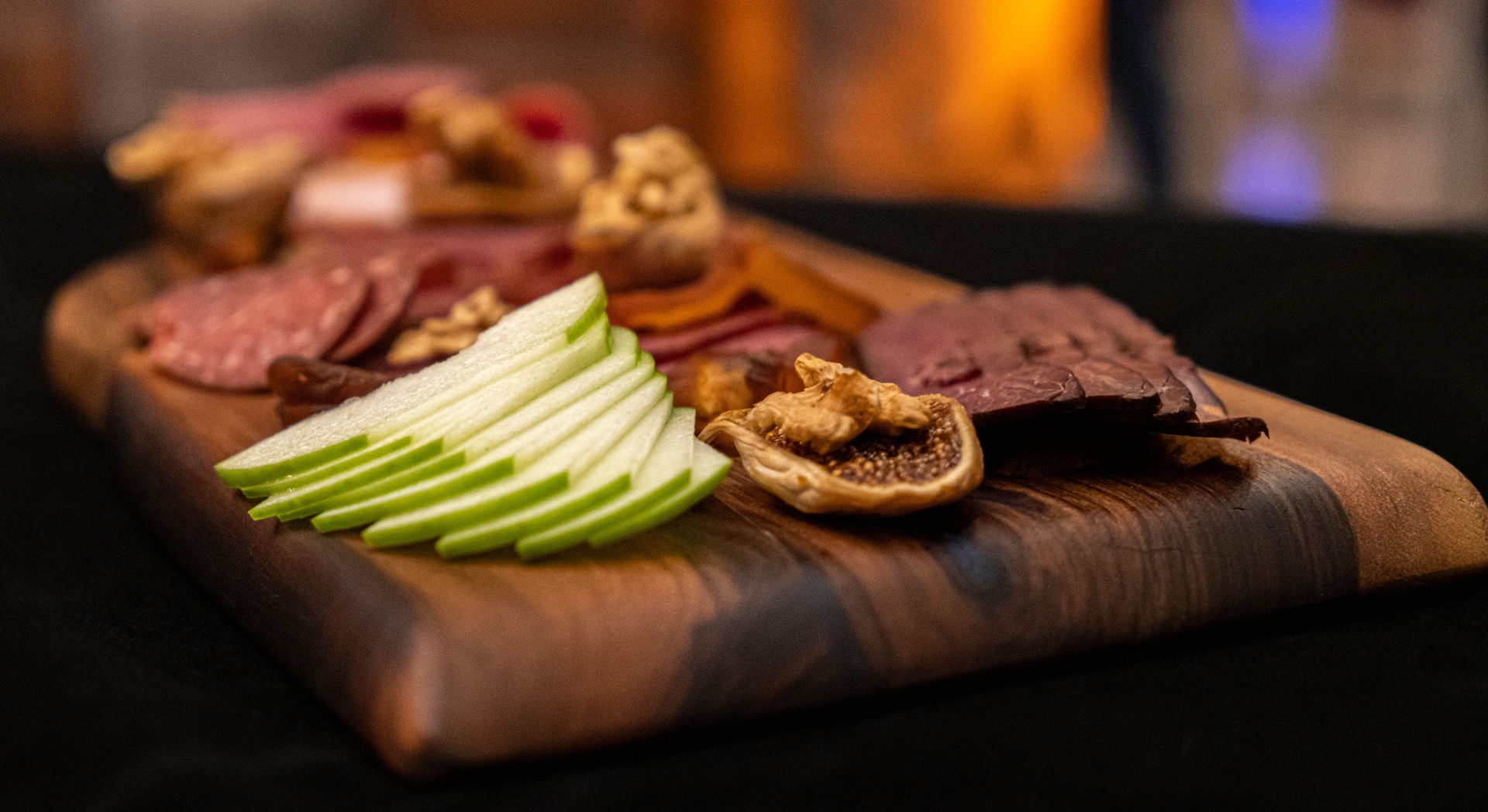 Appetizers table with differents antipasti, charcuterie, snacks and wine. Sausage, ham, tapas, cheese and crackers for buffet party.